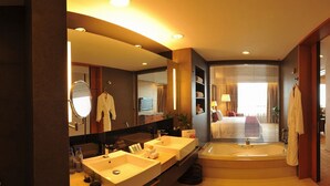 A modern bathroom with dual sinks, a large mirror, and a separate shower area. - Grand Metropark Hotel Kunshan (Suzhou)