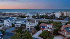 A coastal residential area with houses, a road, and a beach in the background. - Steps to Fenwick Island Beach, Ocean&Bay views, hot tub. Pet & family friendly! (Fenwick Island)