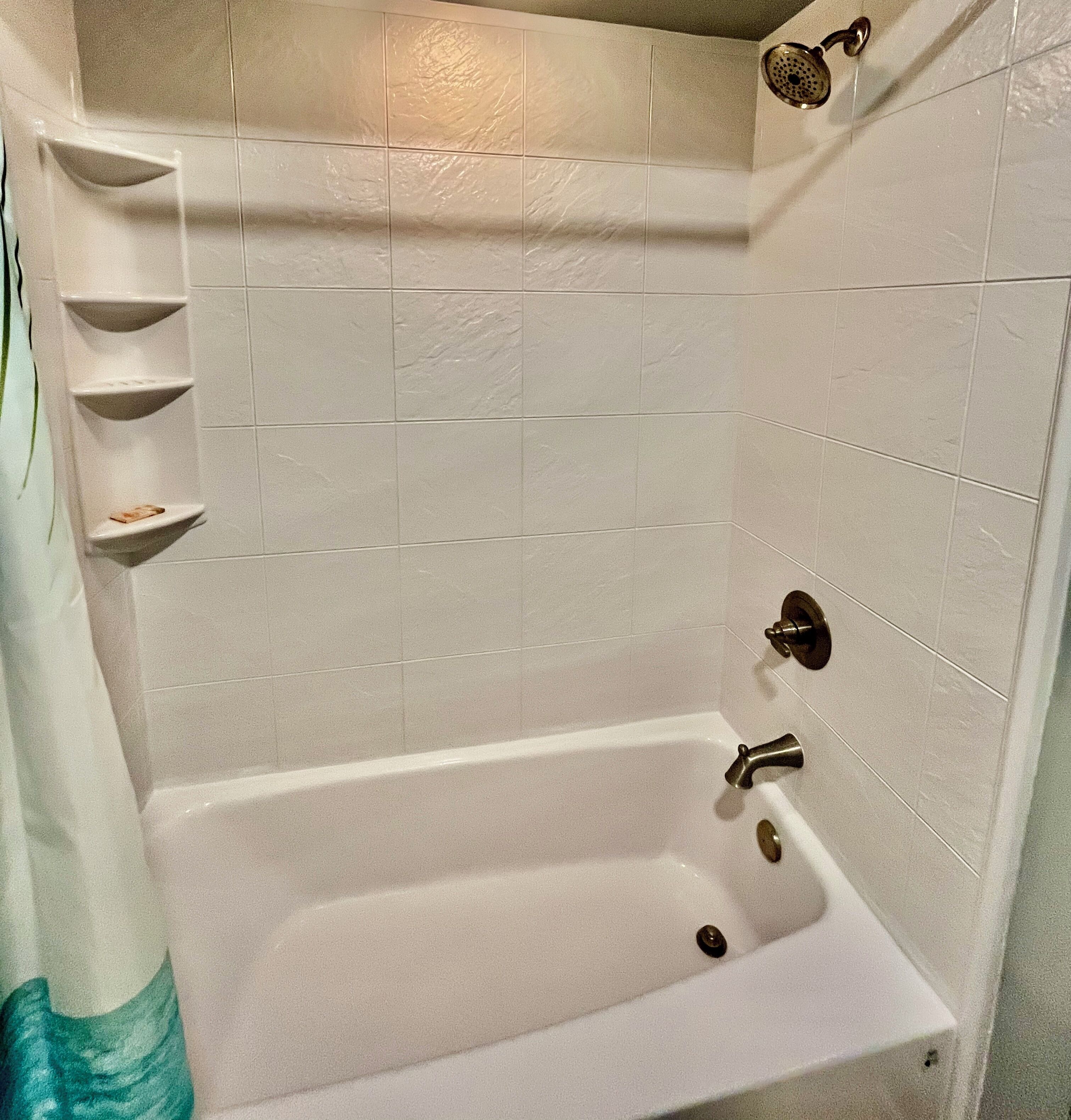 A bathroom with a bathtub, a shower, and a toilet.