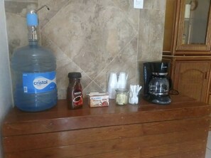 Enjoy a convenient kitchen with a water dispenser, coffee maker, and ample storage for your essentials.
