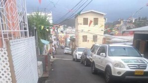 A narrow street with parked cars and buildings on both sides. - Very clean 1-bedroom Apt. in St. Georges, Grenada (Saint George's)