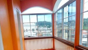A corridor with tiled flooring and large windows. - Very clean 2-bedroom Apt. in St. Georges, Grenada (Saint George's)