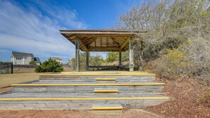 A wooden gazebo with a roof and steps leading up to it. - Emerald Isle Vacation Rental w/ Resort Pool! (Emerald Isle)