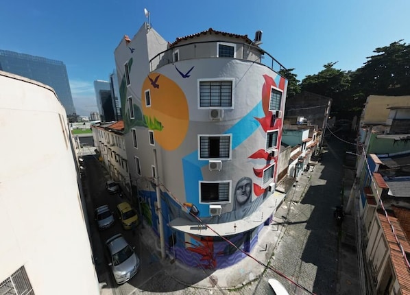 A building with a colorful mural on its exterior, featuring geometric shapes and abstract designs.
