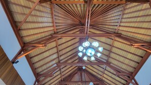 A high ceiling with wooden beams and a central chandelier. - NEW Stunning 3 bed Luxury Balinese Villa with Panoramic Ocean Views and Pool (Bali)