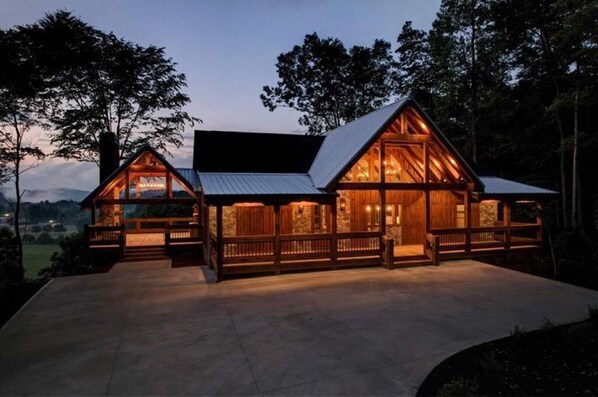 Set amidst the woods, this cabin features a spacious deck and large windows.