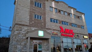 A multi-story building with a sign for 'A.M.R. Fruit Market' on the ground floor.