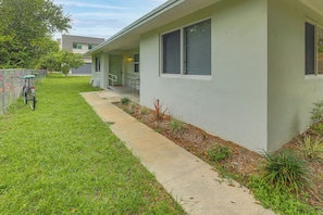 A residential building with a paved walkway, a bicycle, and a small garden area. - Walk to Atlantic Ave & Beach! Home w/ Yard & Patio (Delray Beach)