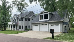 A two-story house with a garage, a basketball hoop, and a mailbox. - Premier Host-Tetonka & Sakatah Lakes Dock, Kayaks, Lakeside Fire Pit & Gameroom (Waterville)