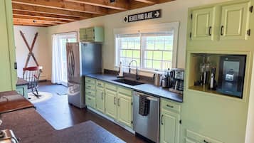 A kitchen with a built-in refrigerator, a coffee maker, and a toaster.