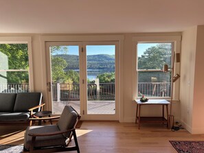 Enjoy a serene lake view from the deck, accessible through a large sliding glass door.