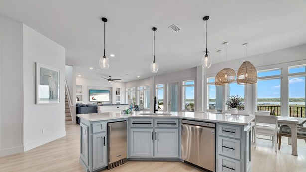 A modern kitchen with a large island, stainless steel appliances, and pendant lighting. - PRIVATE LUXURY HOUSE, COMMUNITY POOL, WATERFRONT ON LITTLE LAGOON! (Gulf Shores)