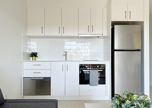 Superior Apartment | Private kitchen | Full-sized fridge, microwave, oven, stovetop - One on Harris Apartments (Wellington Point)