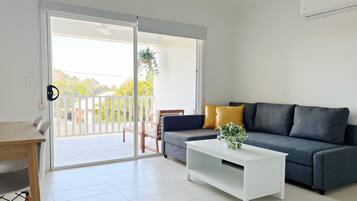 Superior Apartment | Living area | 65-inch Smart TV with digital channels, TV