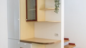 A room with a wooden desk, a window with blinds, a shelf with a plant, and a staircase. - S305 - Sirolo, delightful apartment with porch (Sirolo)