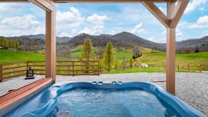 A hot tub with a view of a green landscape and mountains. - NEW Breathtaking Views, Hot tub and Arcade, in a Peaceful Mountain View Retreat (Clyde)