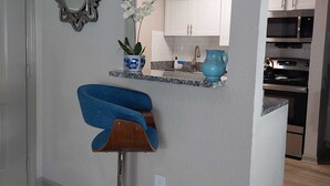 A modern kitchen with white cabinets, a built-in oven, and a microwave. - A peaceful Lake view by The Battery (Smyrna)
