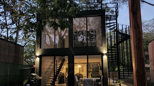 A modern two-story house with a pool, outdoor seating, and a staircase leading to an upper level. - Modern 2 Bedroom Villa - 10 min. Walk to the Beach (Playa Potrero)