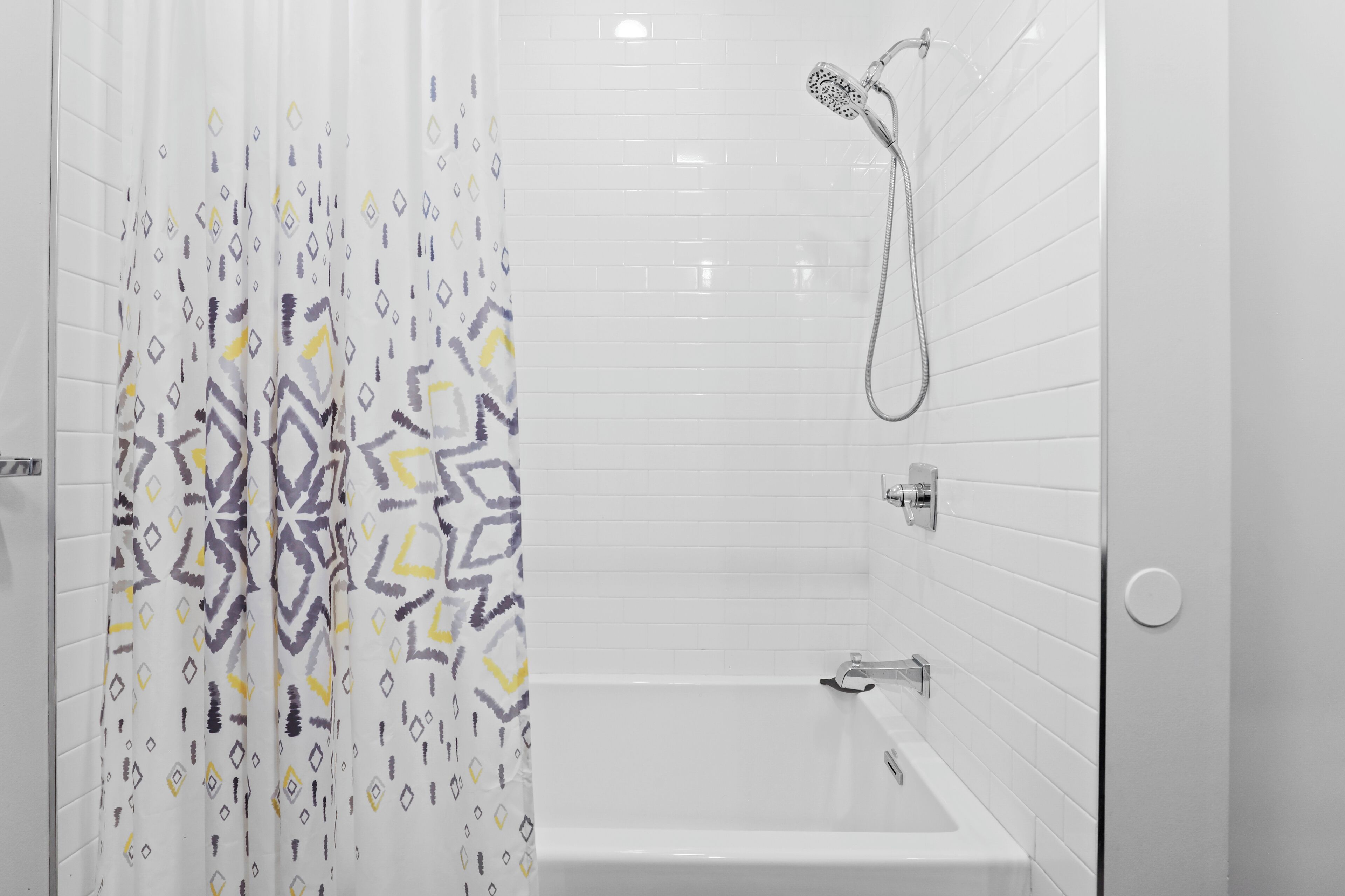 A modern bathroom with a shower, a bathtub, and a toilet.