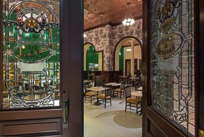 Enjoy dining in this elegant space with classic design, stone walls, and traditional seating.
