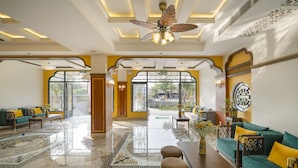 A spacious lobby with a marble floor, a ceiling fan, and a view through large windows. - Soleil by Soluna - A Charming Touch of Hoi An's Heritage (Da Nang)