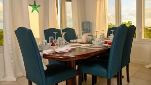 A dining table set with chairs, a water dispenser, and a star decoration on the wall.