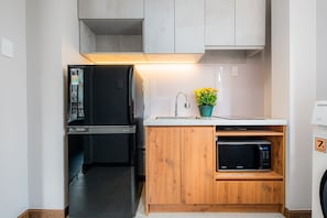 Deluxe Apartment | Private kitchen | Fridge, microwave, cleaning supplies, paper towels