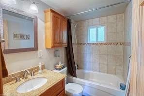Enjoy a relaxing soak in the bathtub or refreshing shower, with a double sink vanity and mirror.