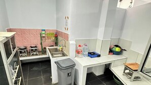 A compact kitchen with a sink, stove, and storage cabinets. - Ambon Residence Syariah (Ambon)