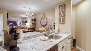 A kitchen with a Keurig coffee maker, a sink, and a clock on the wall. - Mtn-View Condo w/ Lookout Deck in Banner Elk! (Banner Elk)