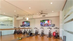 A gym with exercise bikes, a treadmill, and a stationary bike.