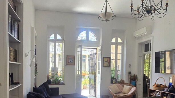 A spacious living area with a patterned floor, a sofa, a dining table, and a chandelier. - Historical apartment in the hart of Jerusalem (Jerusalem)