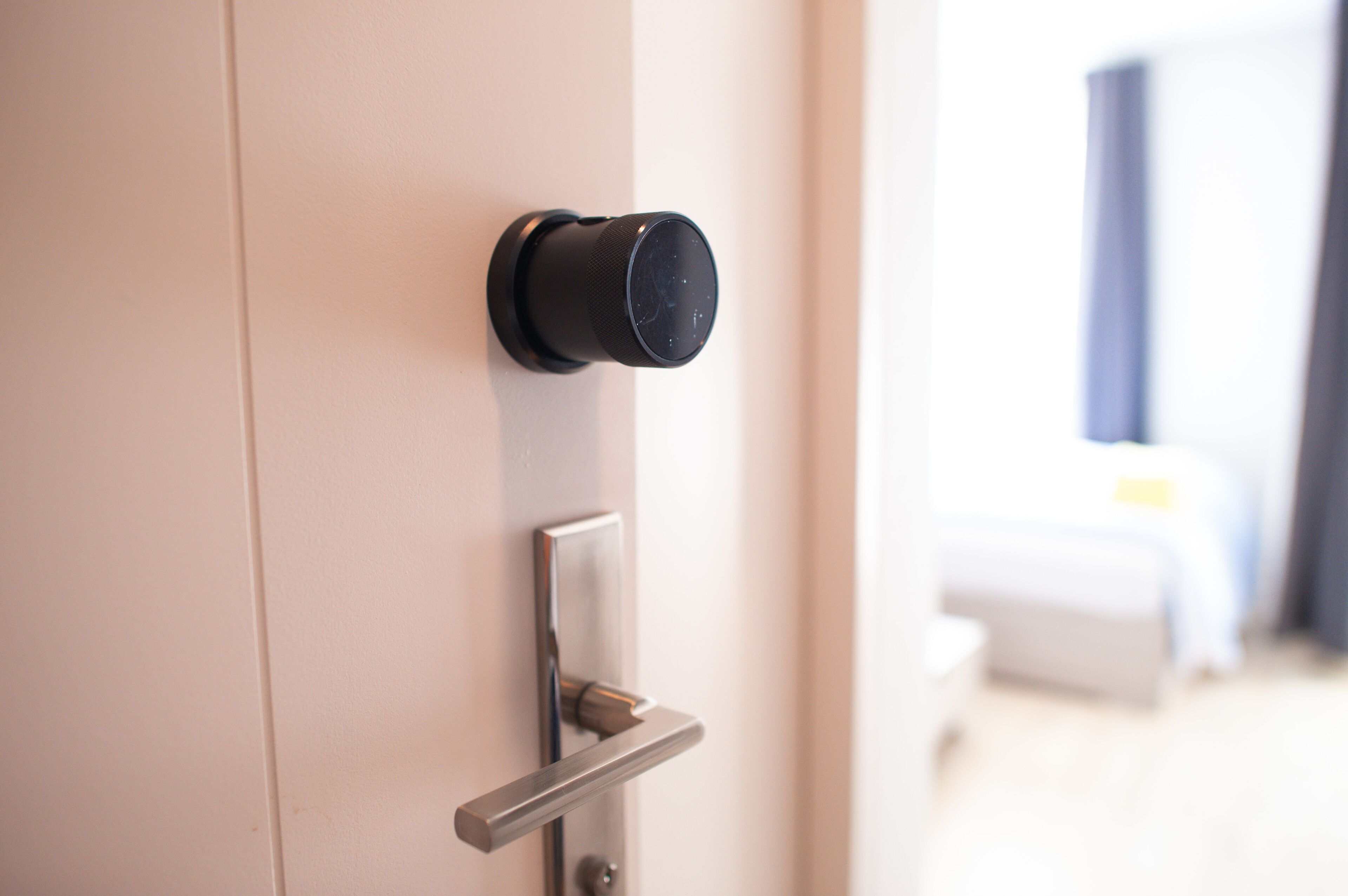 A modern door with a keyhole and a handle.