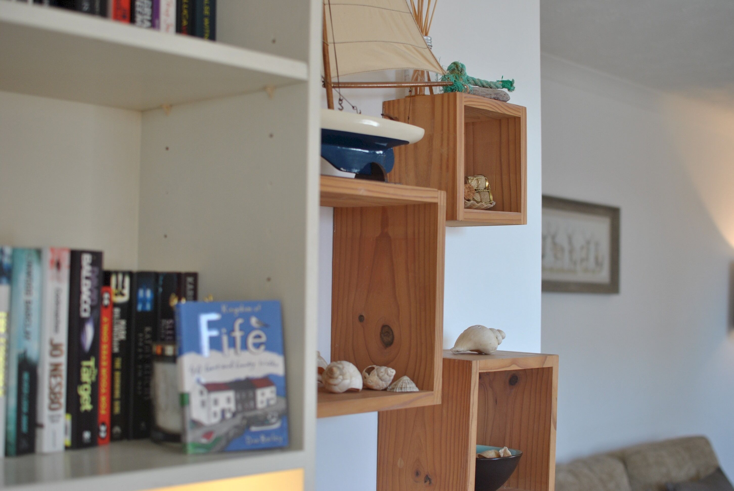 A bookshelf with books and decorative items.