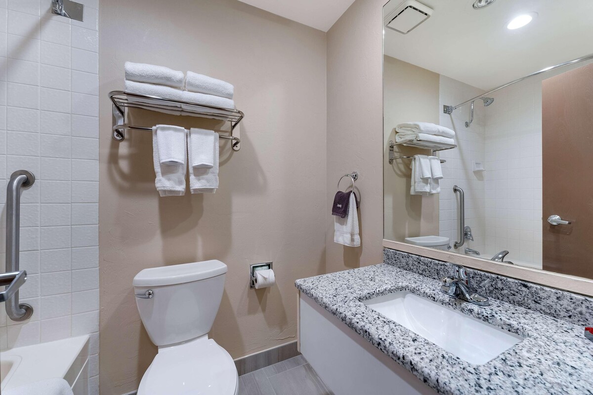 A bathroom with a toilet, sink, and towel rack.