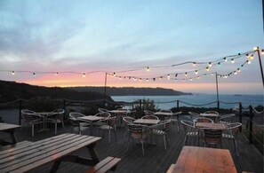 Enjoy al fresco dining with a serene view of the water and the horizon.