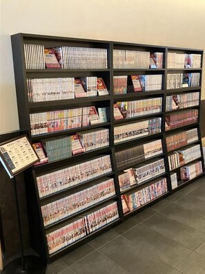 A bookshelf with multiple rows of DVDs and books. - Koko Hotel Osaka Namba (Osaka)