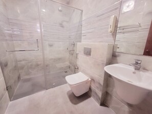 Deluxe Double Room | Bathroom | Shower, rainfall showerhead, free toiletries, slippers - Saubhagya Inn (Lucknow)
