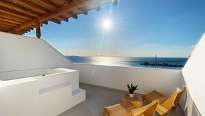A balcony with a view of the sea, wooden furniture, and a small table with a plant. - Calistus Mykonos (Mykonos)