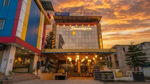 A hotel with a modern facade, a prominent sign, and a well-lit entrance. - Fabhotel Prime Shubh ISBT (Dehradun)