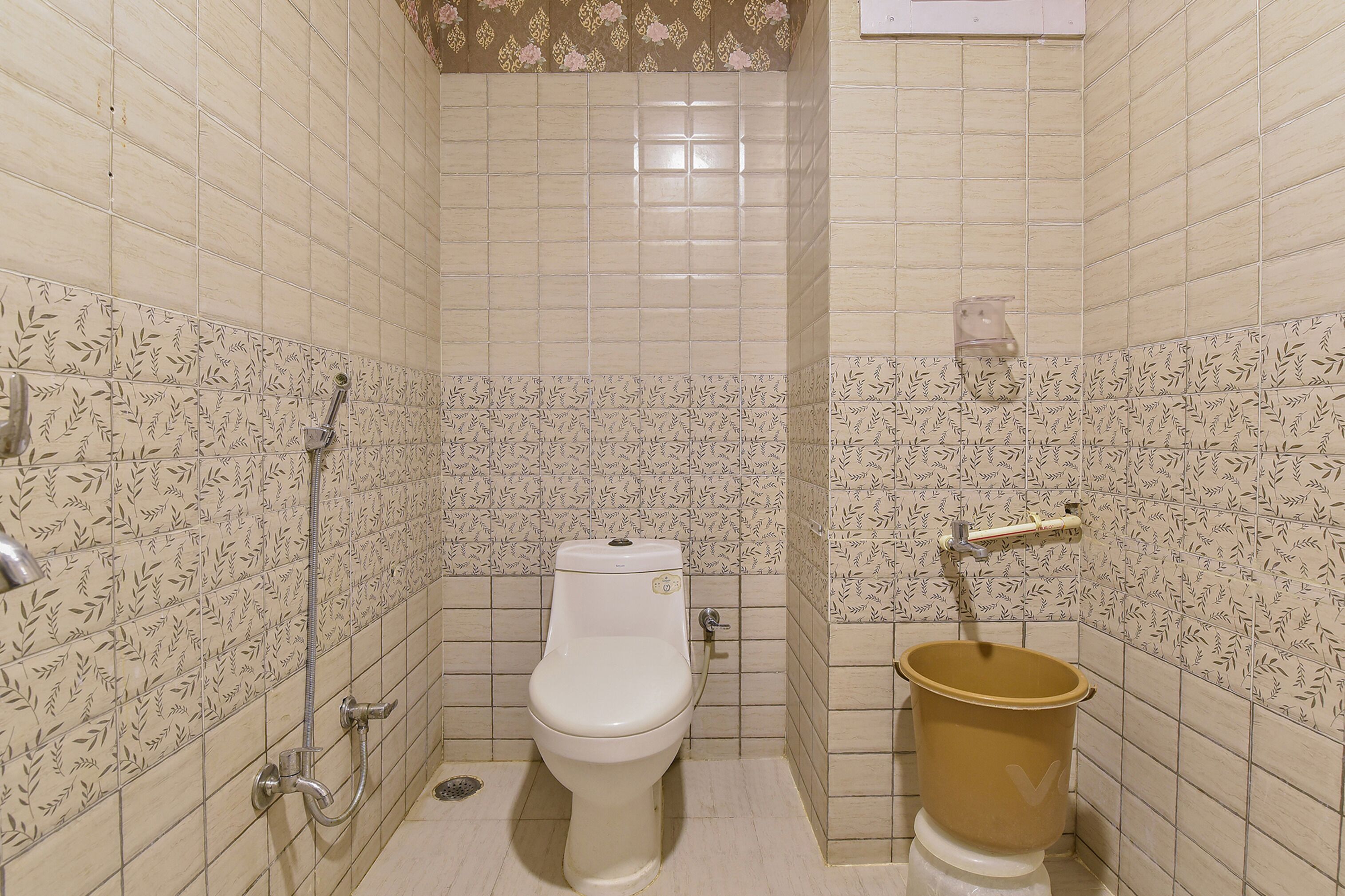 A small bathroom with a toilet, a bidet, and a shower.