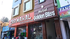 A multi-story building with a 'Hotel Golden Bliss' sign on the third floor. - Fabhotel Golden Bliss (Bhubaneshwar)