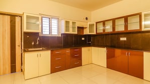 A kitchen with cabinets, a sink, and a window. - Via Direct Checkin - Hitech City (Hyderabad)