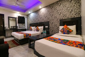 A hotel room with two beds, a desk, a mirror, and a stone-patterned wall. - FabHotel A One Noida Sector 11 (Noida)
