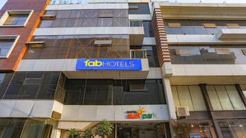 A multi-story building with a 'fab hotels' sign and a 'sun park' sign below it.