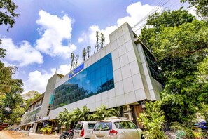 A modern hotel building with a blue facade and a sign indicating it is a hotel. - Veera Residency (Mumbai)