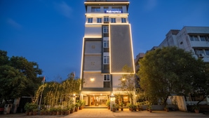 A tall hotel building with a sign reading "FabHotels" at the top. - Via Corner Courtyard (Hyderabad)