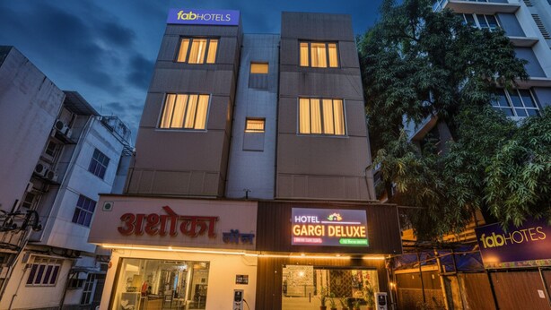 A hotel building with a sign for 'fabHOTELS' and 'HOTEL GARGI DELUXE'. - Fabhotel Gargi Deluxe (Pune)