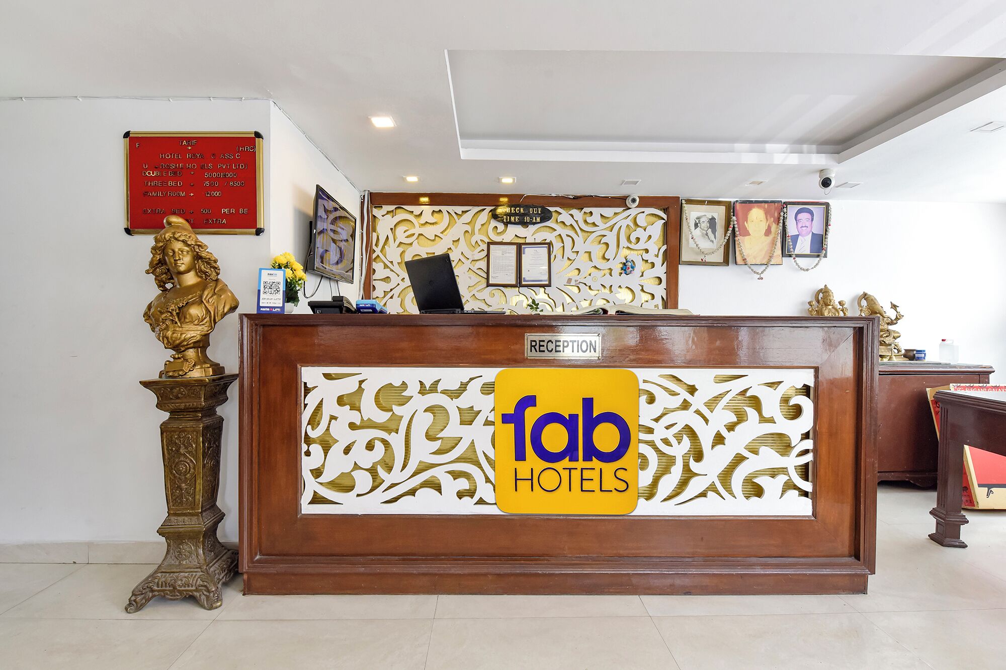 A reception desk with a 'fab hotels' sign, a three-bedroom room option, and a family room.