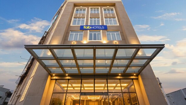 A modern hotel with a glass entrance and a sign reading "fabHOTELS". - FabHotel Sapphire 83 Best hotel in Manesar, Gurugram (Gurugram)